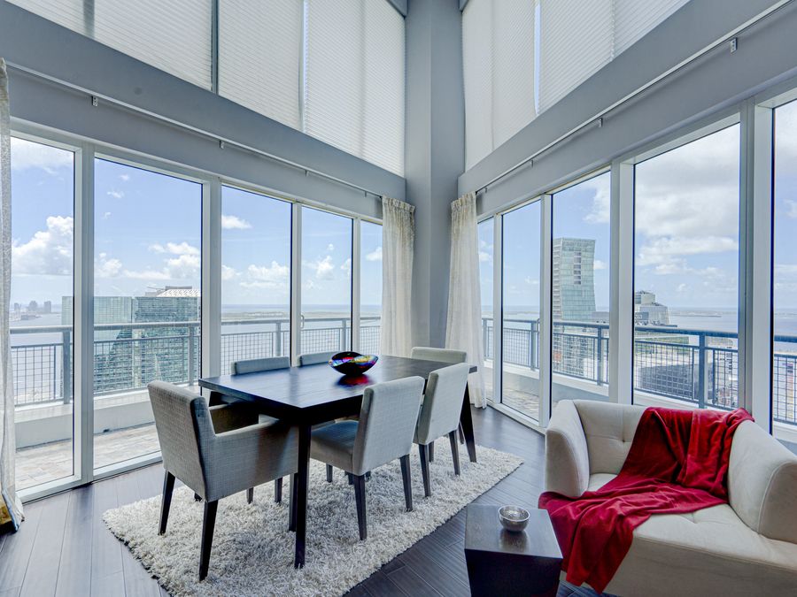 Brickell penthouse dining room with double-height ceilings and panoramic Miami skyline